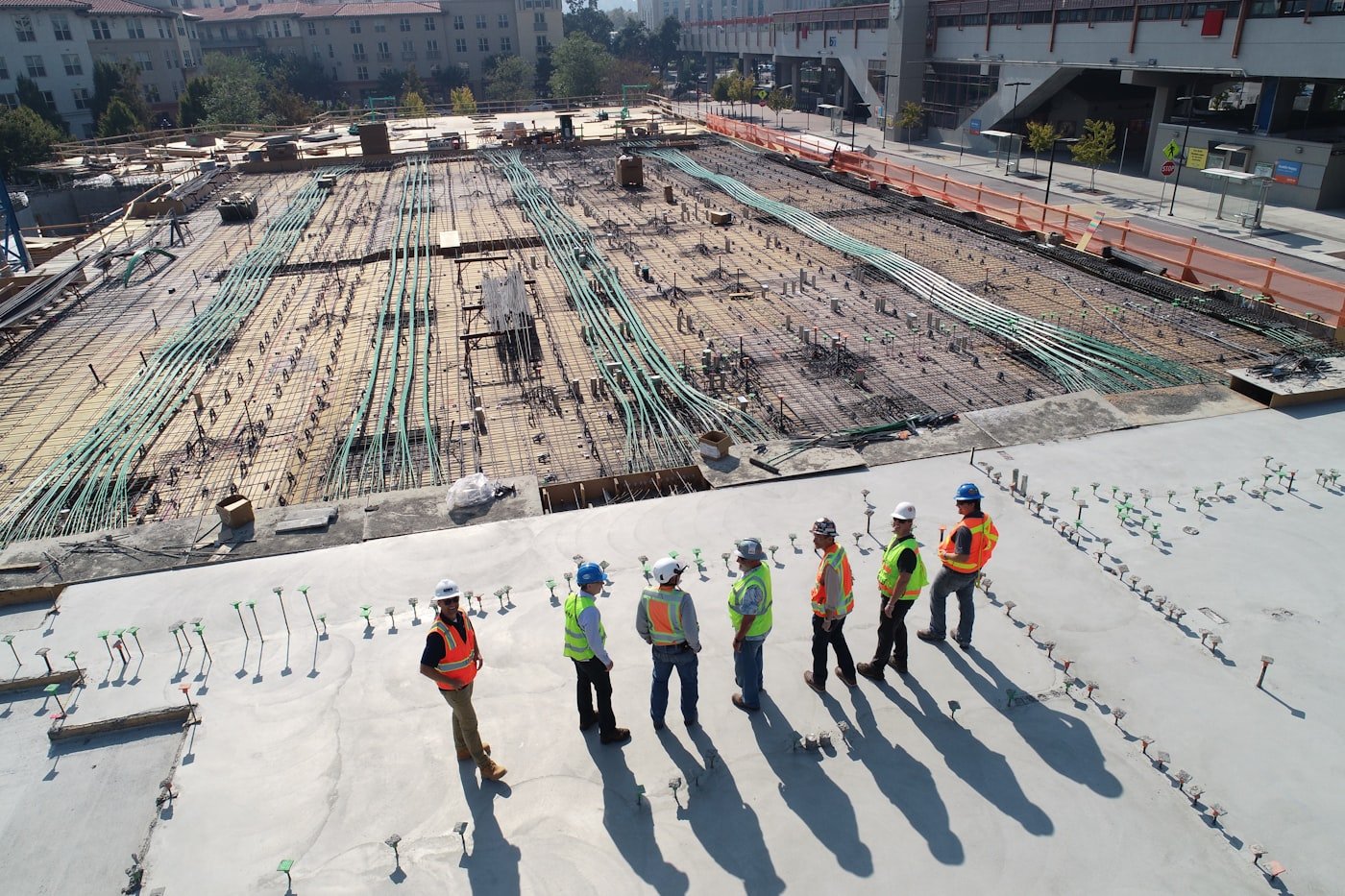 Construction workers reviewing blueprints on site
